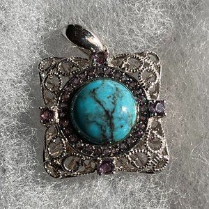 Turquoise and amethyst in silver tone pendant